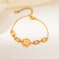 Detailed macro view of a gold flower bracelet with emerald-cut crystals and adjustable chain - Flower Rectangular White Style (BJGB0020B)