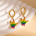 Macro shot of rainbow-colored I Love You gesture earrings in polished gold steel - I Love You Hand Sign Rainbow Earrings (BJGE1190)