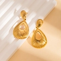 Detail of golden teardrop hollow earrings with radial texture on a white display stand - Stripe Earrings (BJGE1370)