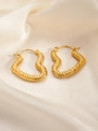 Detail shot of golden heart hoop earrings with hammered texture on white silk background - Heart E0170 Style