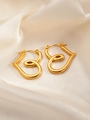 Detailed view of glossy gold heart-shaped hoop earrings on elegant beige silk fabric - Heart E0172 Style