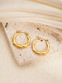 Elegant gold hoop earrings with embossed texture on silk and stone background - Round E0263 Style