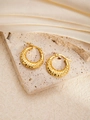 Hammered gold titanium steel hoop earrings on stone and silk fabric display - Round E0269 Style