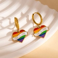 Rainbow heart charm earrings in gold finish with Love Is Love engraving on a white tray - Love is Love Heart Earrings (BJGE1201)