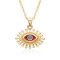 Macro detail of gold-plated evil eye pendant with blue resin and sunburst rays - Oval Red Blue Black Eye Style (B260)