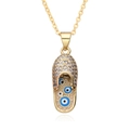 Detailed macro view of gold slipper pendant with micro-pave zircons and evil eye charms - Blue Slipper Style (h088)