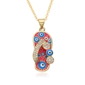 Macro shot of pink flip-flop pendant with evil eye pattern and sparkling rhinestones - Pink (h007)