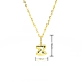 Detail of gold bubble letter Z pendant with purple cubic zirconia stones on the bail - Gold Style Z