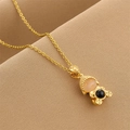 Golden titanium steel Buddha necklace with inlaid gemstones on brown textured background - Gold