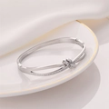 Polished stainless steel knot cuff bracelet with pavé rhinestones in a silver tone - Silver