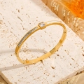 Gold plated cuff bracelet with square zircon and shell inlay on textured stone - Gold