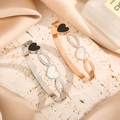 Elegant gold heart titanium steel bangles in rose gold and silver on stone and silk - Silver