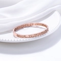 Rose gold Great Wall pattern cuff bracelet in hollow design on white silk background - Rose Gold