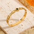 Polished gold titanium steel bangle with black shell inlay and crystal accents - Gold