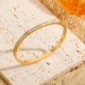 Elegant 18K gold titanium steel bangle featuring a full row of shimmering cubic zirconia stones - Gold