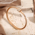 Rose gold stainless steel bracelet with three sliding rhinestone rings on travertine base - Rose Gold