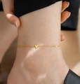Elegant gold titanium steel double heart anklet shown on an ankle for women - Three Hearts Anklet / Gold