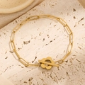 Gold paperclip chain jewelry set with a unique plum blossom OT clasp on stone texture - Gold Flower Paperclip Bracelet