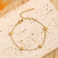 Close-up of gold heart charm bracelet in stainless steel with lobster clasp detail - Gold Heart Bracelet