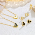 Elegant gold minimalist heart jewelry set with black and white enamel on a stone surface - Black Shell Heart Stud Earrings (E180)