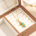 Detail of vintage turquoise pendant with golden metal texture on white velvet padding - Geometric Oval Turquoise Necklace (0852)