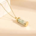 Golden stainless steel necklace featuring a clear tube pendant with green natural stones - Green Stone Style (0843)