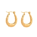 Macro detail of gold horseshoe earrings with embossed cross pattern on white background - Gold Cross Style (CBGE0047JS)