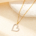 Close-up of golden heart-shaped necklace with paved stones on a natural stone base - Gold White Zircon Heart