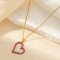 Detail of gold heart pendant necklace with shimmering pink zirconia on silk background - Gold Rose Red Zircon Heart