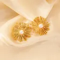 Detailed view of golden sunburst earrings with centered pearls on champagne silk fabric - Stamen Artificial Pearl Style (0497)