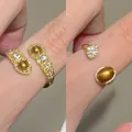 Detail of adjustable gold-plated ring set with tiger eye stone and sparkling crystals - 虎眼戒指套装(2个装) / Gold