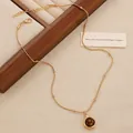Detailed macro of vintage tiger eye stone pendant on golden layered beaded necklace chain - Gold (9735)