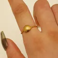 Macro detail of a gold seashell ring featuring a textured band and realistic shell design - Shell Style (6564) / Gold