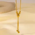 Detail of gold snake chain necklace featuring elegant bead tassels and polished metal finish - Gold Multiple Beads