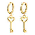 Detailed macro view of golden heart key pendant earrings with polished finish and hoops - Gold Key And Heart Style