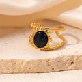 Detailed view of an 18K gold plated open ring featuring an oval cat-eye stone and beaded band - Ink Black (R0826)