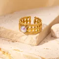 Golden open ring with vintage woven texture and iridescent opal gemstone on stone background - Braided Iridescent Stone Adjustable Style (TYR0835)