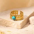 Close-up of vintage gold hollow woven ring with a turquoise stone on a stone background - Braided Turquoise Adjustable Style (TYR0834)