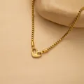 Macro detail of gold box chain necklace featuring a heart clasp engraved with I Am Worthy - Gold i am worthy Heart