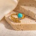 Detailed macro view of 18k gold plated leaf ring featuring a round turquoise stone insert - Wheat Texture Turquoise Adjustable Style (TYR1138)