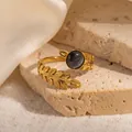 Macro detail of a vintage 18k gold-plated ring with a grey cat-eye stone and leaf patterns - Leaf Texture Dark Grey Stone Adjustable Style (TYR1142)