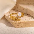 Detailed close-up of 18k gold plated leaf ring with a pearl inlay on a stone tray - Wheat Texture White Stone Adjustable Style (TYR1141)