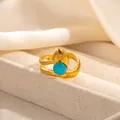 Macro shot of gold adjustable ring featuring a blue round gemstone and vintage metal leaf detail - Water Drop Decor Blue Stone Style (R1213)
