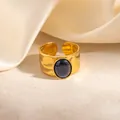 Detailopname van de gehamerde gouden ring met ovale blauwe steen op zijden achtergrond - Donkerblauw (R1253)