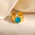 Detail of gold hammered texture ring featuring a blue cat's eye gemstone on silk background - Blue Cat's Eye (R1250)