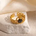 Macro shot of gold crown ring with black stone and elegant hollow wavy band detail - Crown Design Black Natural Stone Adjustable Style (TYR1350)