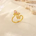 Detail showing pink zircon butterfly and flower motifs on gold stainless steel ring - Butterfly Small Flower Pink Stone Style (G127914)