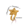 Macro shot of gold star-shaped stainless steel ring showing detailed sunburst patterns - Embossed Pentagram Style (G129109)