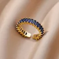 Macro detail of 18K gold-plated ring with emerald-cut blue cubic zirconia stones - Pave Baguette Dark Blue Style (JZ4470G-3)