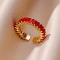 Close-up of adjustable 18K gold plated ring with emerald cut red zircon on silk fabric - Pave Baguette Red Style (JZ4470G-6)